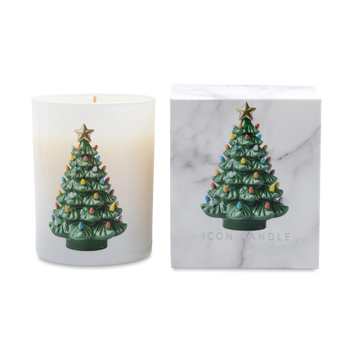 A holiday-themed scented candle in a frosted white glass jar next to its white marble-patterned packaging box. Both feature a green Christmas tree with colorful lights and a gold star on top.
