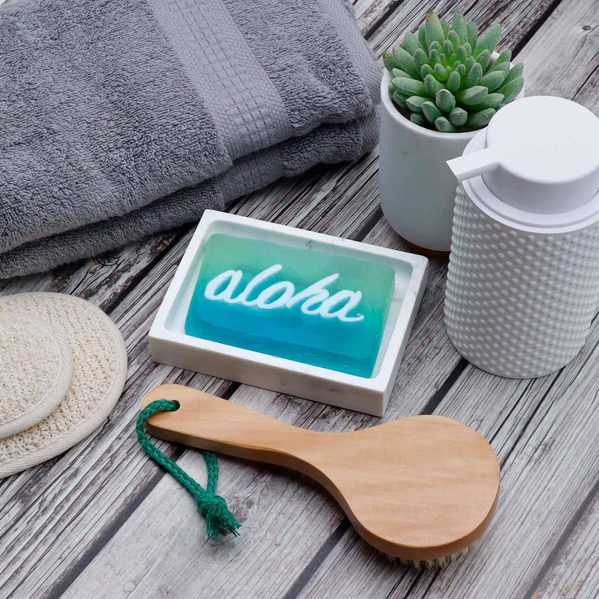 Aloha Glycerin Bar Soap featuring a two-tone aqua and turquoise blue design with the word aloha in white script