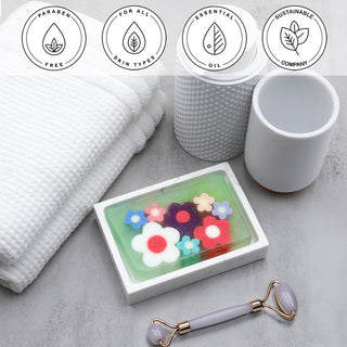 Flowerchild Vegetable Glycerin Bar Soap in a white dish on a stone surface.