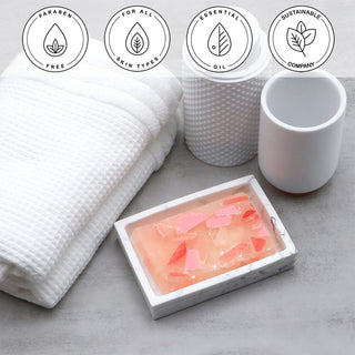 Himalayan Pink Sea Salt Vegetable Glycerin Bar Soap in a white dish on a stone surface.