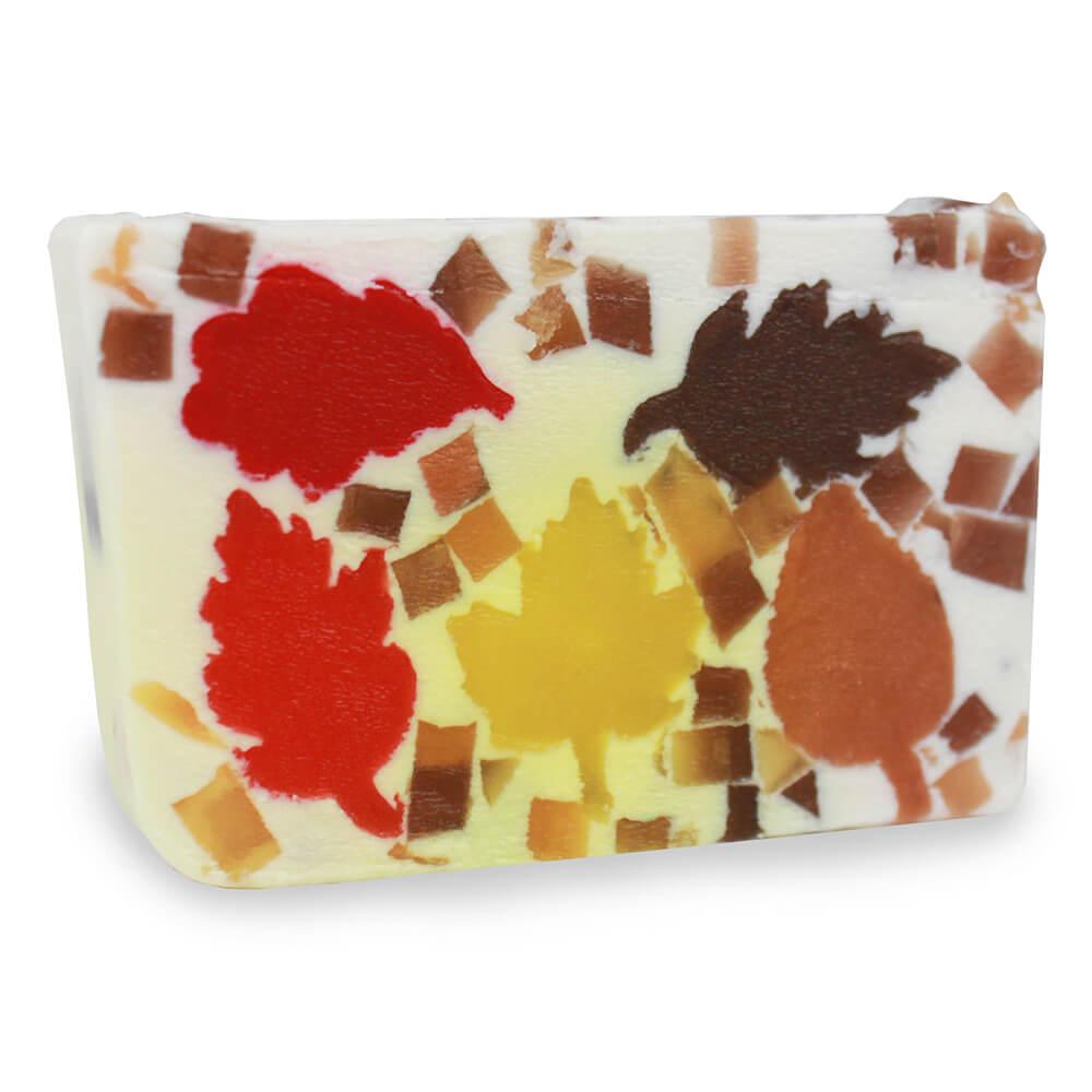 Autumn Leaves glycerin bar soap with red, yellow, amber, and brown leaf shapes surrounded by small autumn-colored soap pieces.