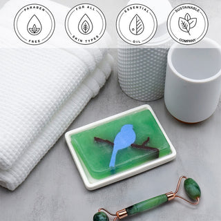 Bamboo Charcoal Vegetable Glycerin Bar Soap in a white dish on a stone surface.