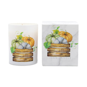 A white wax candle in a cylindrical glass vessel with a watercolor illustration of stacked wooden crates holding green, blue-gray, and orange pumpkins with leaves, shown next to its white marble-patterned box. The box is printed with the brand name 'ICON CANDLE'.