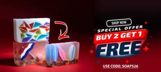 Three decorative rectangular bars of soap displayed on a red gradient background with promotional text on the right reading 'SHOP NOW', 'SPECIAL OFFER', 'BUY 2 GET 1 FREE', and 'USE CODE: SOAPS26'.
