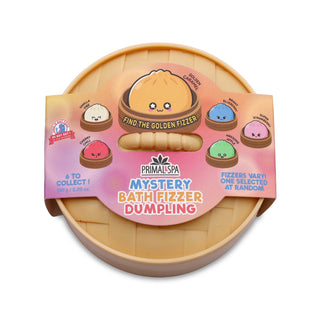 Primal Spa Mystery Bath Fizzer Dumpling in its original packaging, featuring a round beige plastic container with a pink and orange cardboard sleeve displaying cartoon dumpling illustrations.