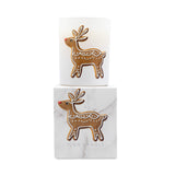A white scented candle in a cylindrical glass holder with a gingerbread deer design on the front, shown above its matching white marble-patterned box. The box features the same gingerbread deer illustration and the text 'ICON CANDLE' at the bottom.