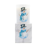 A white glass candle jar with a watercolor snowman illustration, shown with its matching white marble-patterned box. The box features the brand name 'ICON CANDLE' at the bottom.