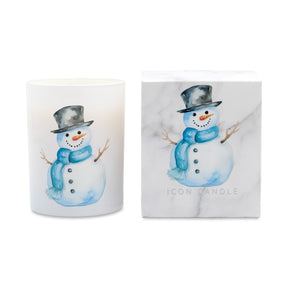 A white glass candle jar and its matching marble-patterned box, both featuring a watercolor illustration of a snowman wearing a black top hat and blue scarf. The brand name 'ICON CANDLE' is printed on the box.
