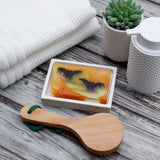 Bats glycerin bar soap featuring two black bats across a yellow moon with orange swirls in a translucent rectangular bar.