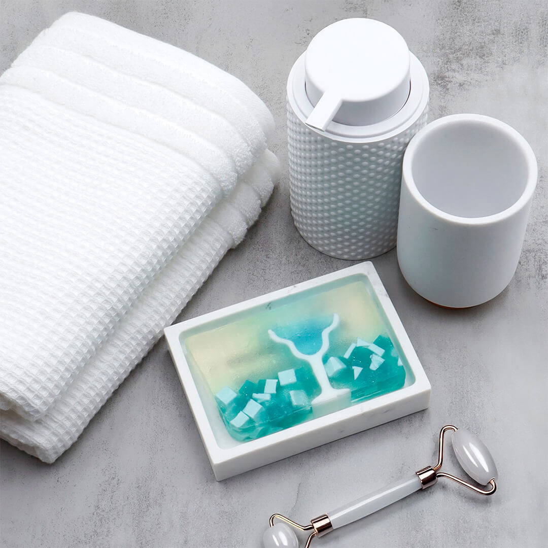 Blue Margarita glycerin bar soap featuring a blue margarita glass, green lime garnish, and teal and white soap pieces in a translucent bar.