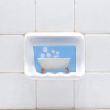 Bubble Bath glycerin bar soap featuring a cream bathtub with orange feet and floating white bubbles in a translucent light-blue bar.