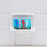 A Day at the Races aqua glycerin bar soap with colorful blue, pink, red, and white seahorses suspended in a translucent ocean-inspired design