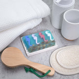 A Day at the Races aqua glycerin bar soap with colorful blue, pink, red, and white seahorses suspended in a translucent ocean-inspired design