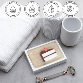 Birthday Cake Vegetable Glycerin Bar Soap in a white dish on a stone surface.
