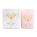 Pink glass candle with champagne glass design and matching box on a white background