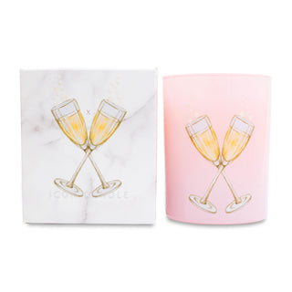 Pink glass candle with champagne glass design and matching box on a white background