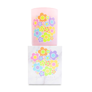 Pink candle with colorful floral design on top of matching white box on a white background