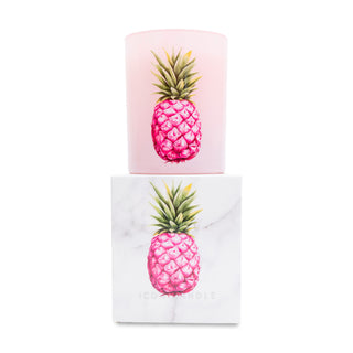 Pink pineapple candle on top of matching white box on a white background