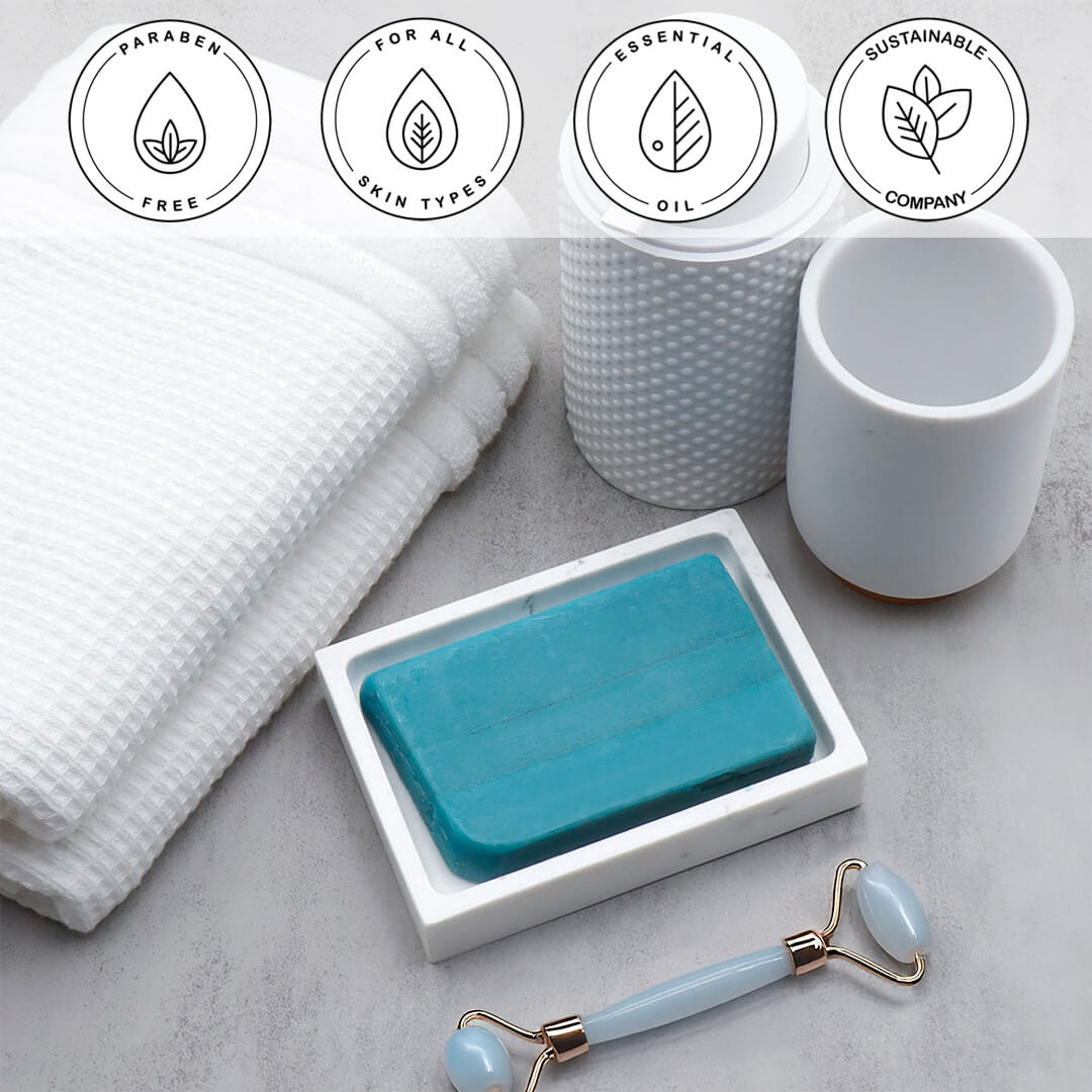Dead Sea Mud Vegetable Glycerin Bar Soap in a white dish on a stone surface.