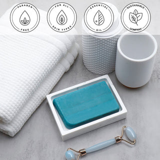 Dead Sea Mud Vegetable Glycerin Bar Soap in a white dish on a stone surface.