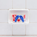 Flip Flops Vegetable Glycerin Bar Soap in a white soap dish on a tiled bathroom wall.