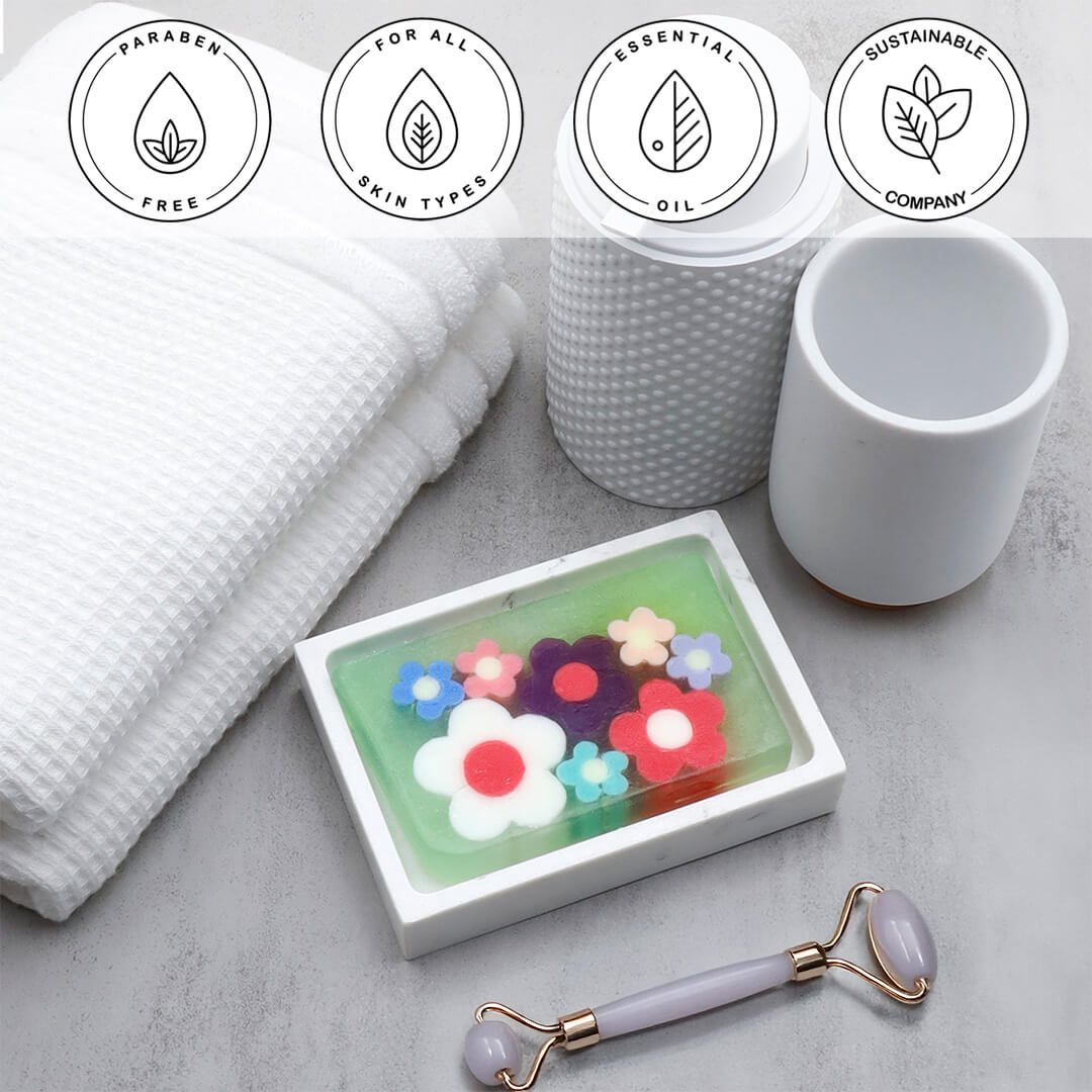 Flowerchild Vegetable Glycerin Bar Soap in a white dish on a stone surface.