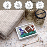Football Vegetable Glycerin Bar Soap in a white dish on a stone surface.