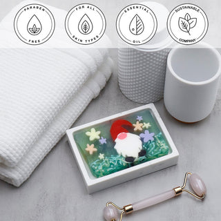 Garden Gnome Vegetable Glycerin Bar Soap in a white dish on a stone surface.