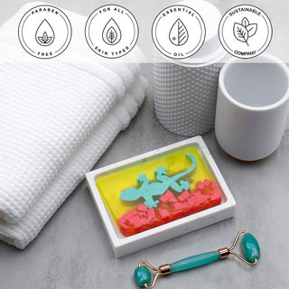 Gecko Vegetable Glycerin Bar Soap in a white dish on a stone surface.