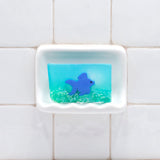 Ginger Fish Vegetable Glycerin Bar Soap in a white soap dish on a tiled bathroom wall.