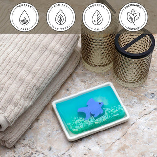 Ginger Fish Vegetable Glycerin Bar Soap in a white dish on a stone surface.