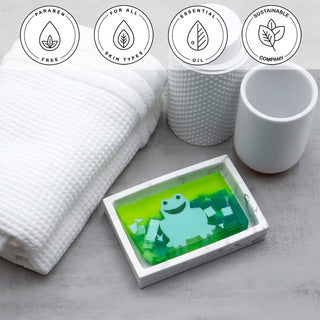 Green Frog Vegetable Glycerin Bar Soap in a white dish on a stone surface.