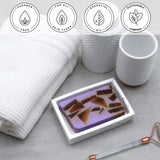 Lavender Essential Oil Vegetable Glycerin Bar Soap in a white dish on a stone surface.