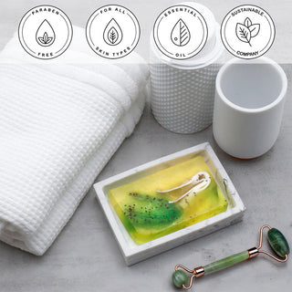 Lemongrass & Cranberry Seeds Vegetable Glycerin Bar Soap in a white dish on a stone surface.