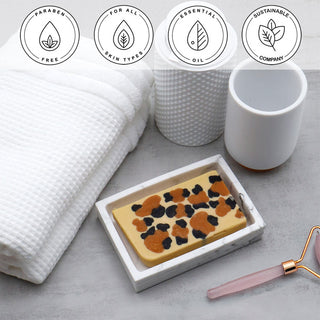 Leopard Vegetable Glycerin Bar Soap in a white dish on a stone surface.