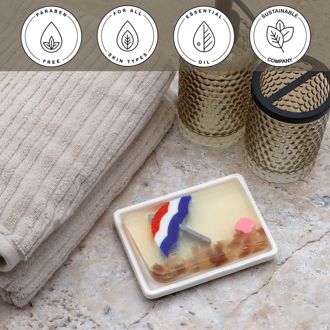 Life's a Beach Vegetable Glycerin Bar Soap in a white dish on a stone surface.