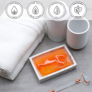 Tomato Juice Complexion Vegetable Glycerin Bar Soap in a white dish on a stone surface.