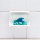 Tranquility Vegetable Glycerin Bar Soap in a white soap dish on a tiled bathroom wall.