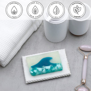 Tranquility Vegetable Glycerin Bar Soap in a white dish on a stone surface.