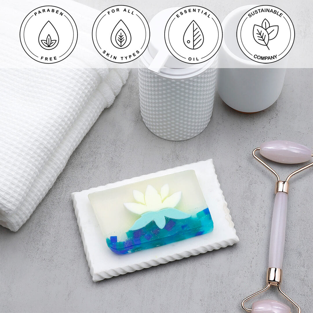 White Lotus Vegetable Glycerin Bar Soap in a white dish on a stone surface.